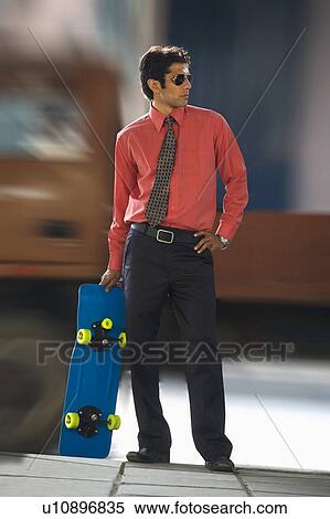 Stock Photography - Executive with a skateboard. Fotosearch