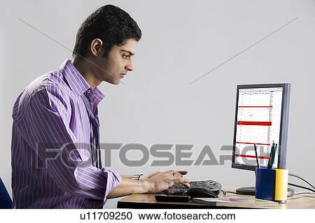 Executive working at his desk View Large Photo Image Stock Image - Executive working at his desk. Fotosearch