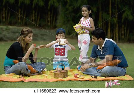 Family enjoying at a picnic View Large Photo Image Stock Image - Family enjoying at a picnic. Fotosearch