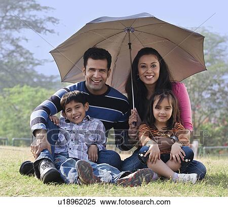 Family posing with an umbrella View Large Photo Image Stock Photography - Family posing with an umbrella. Fotosearch