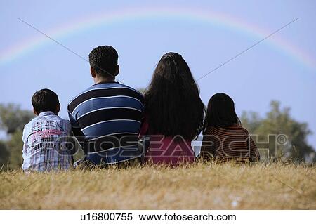Family sitting in a park View Large Photo Image Stock Photography - Family sitting in a park. Fotosearch