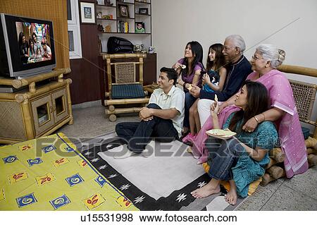 Family watching television View Large Photo Image Stock Photo - Family watching television. Fotosearch