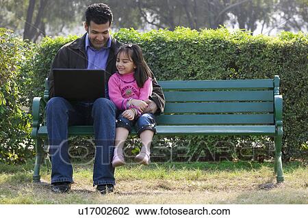 Stock Image - Father and daughter with a laptop. Fotosearch