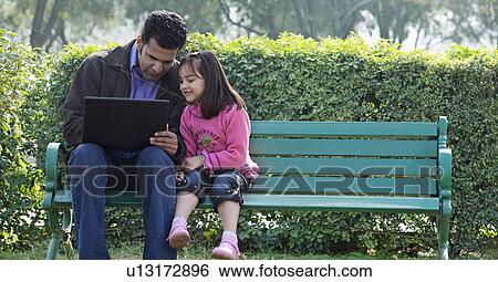 Stock Photograph - Father and daughter with a laptop. Fotosearch