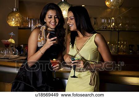 Friends at a bar View Large Photo Image Stock Photo - Friends at a bar. Fotosearch