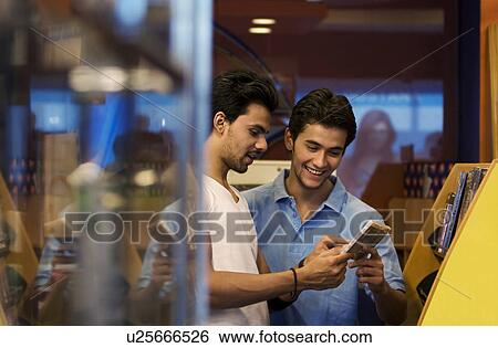 Stock Photograph - Friends at a music store. Fotosearch