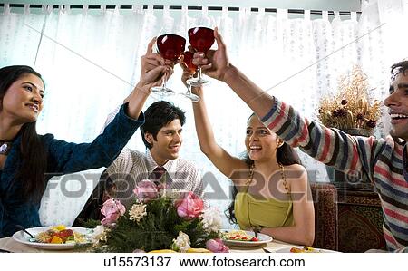 Stock Photo - Friends celebrate together. Fotosearch
