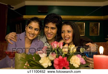 Friends enjoying a meal View Large Photo Image Stock Image - Friends enjoying a meal. Fotosearch