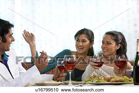 Friends enjoying a meal View Large Photo Image Stock Image - Friends enjoying a meal. Fotosearch