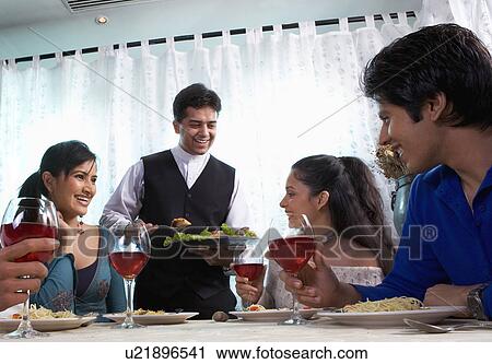 Friends enjoying a meal View Large Photo Image Stock Image - Friends enjoying a meal. Fotosearch