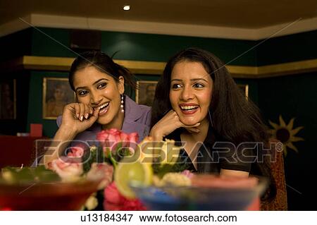 Stock Photo - Friends enjoying a meal. Fotosearch