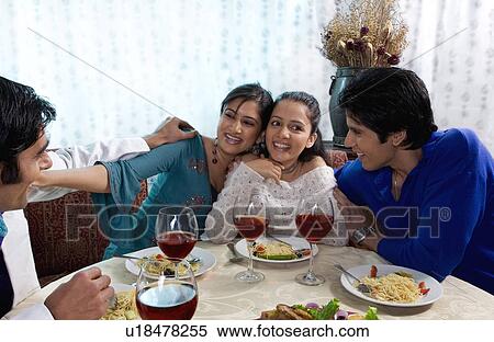 Friends enjoying a meal View Large Photo Image Stock Photography - Friends enjoying a meal. Fotosearch
