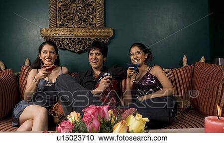 Stock Image - Friends enjoying their drink. Fotosearch