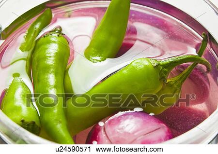 Stock Image - Green chillies and onions. Fotosearch