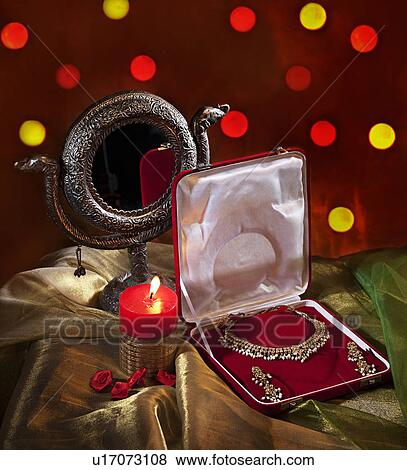 Stock Photo - Jewelery set and candle. Fotosearch