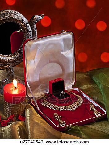 Stock Photo - Jewelery set and candle. Fotosearch
