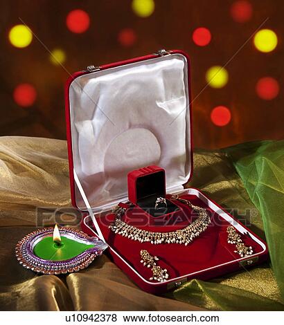 Stock Photo - Jewelery set and diya. Fotosearch