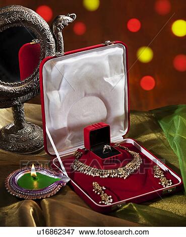 Stock Photo - Jewelery set and diya. Fotosearch