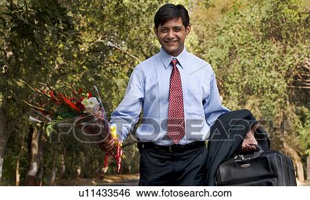 Stock Photograph - Man holding a bouquet of flowers. Fotosearch