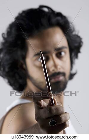 Stock Photo - Man holding a pencil. Fotosearch
