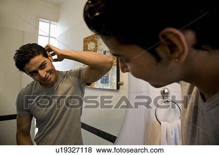 Stock Photo - Man looking in the mirror. Fotosearch