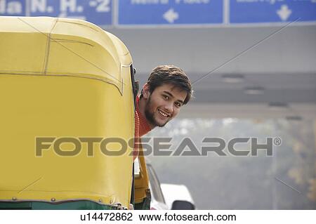 Man looking out of an autorickshaw View Large Photo Image Stock Image - Man looking out of an autorickshaw. Fotosearch