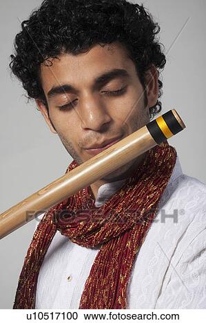 Stock Image - Man playing the flute. Fotosearch