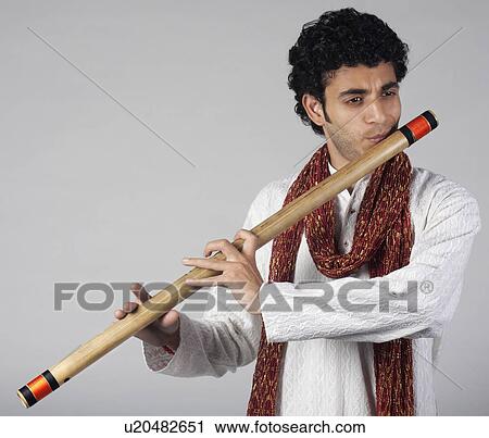 Stock Image - Man playing the flute. Fotosearch