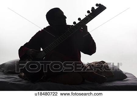 Stock Image - Man playing the sitar. Fotosearch