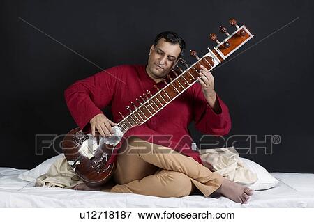 Stock Photo - Man playing the sitar. Fotosearch
