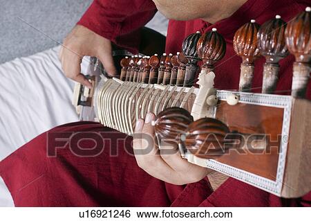 Man playing the sitar View Large Photo Image Stock Photograph - Man playing the sitar. Fotosearch