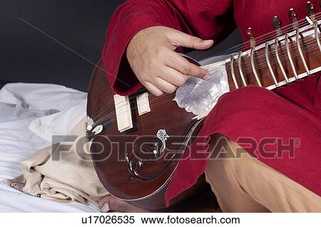 Stock Photography - Man playing the sitar. Fotosearch
