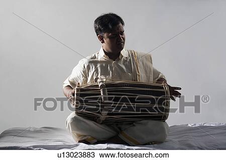 Stock Image - Man playing the tabla. Fotosearch
