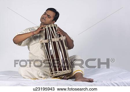 Stock Image - Man playing the tabla. Fotosearch