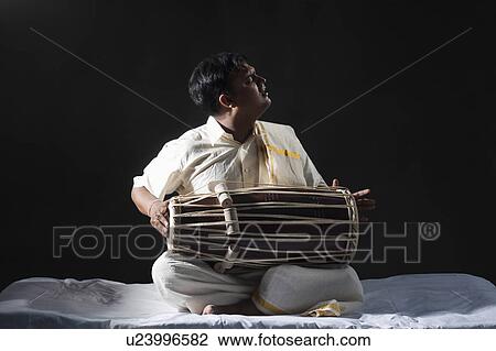 Stock Image - Man playing the tabla. Fotosearch