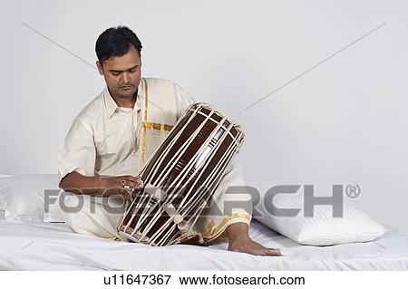 Stock Photo - Man playing the tabla. Fotosearch