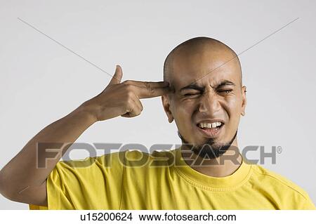 Man pretending to shoot himself View Large Photo Image Picture - Man pretending to shoot himself. Fotosearch