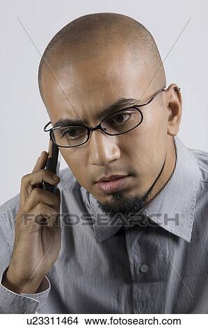 Picture - Man talking on a mobile phone. Fotosearch