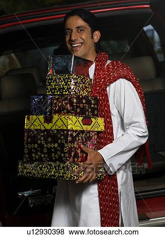Stock Photo - Man with gifts on Diwali. Fotosearch
