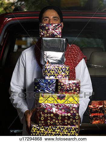 Man with gifts on Diwali View Large Photo Image Stock Photo - Man with gifts on Diwali. Fotosearch