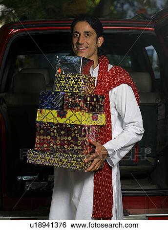 Man with gifts on Diwali View Large Photo Image Stock Photograph - Man with gifts on Diwali. Fotosearch