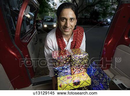 Stock Photography - Man with gifts on Diwali. Fotosearch