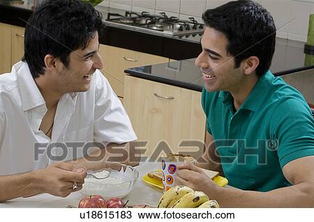 Stock Image - Men having breakfast. Fotosearch