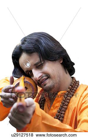 Stock Photo - Minstrel having fun with an ektara. Fotosearch