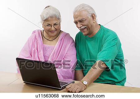 Stock Photo - Old couple working on the laptop. Fotosearch
