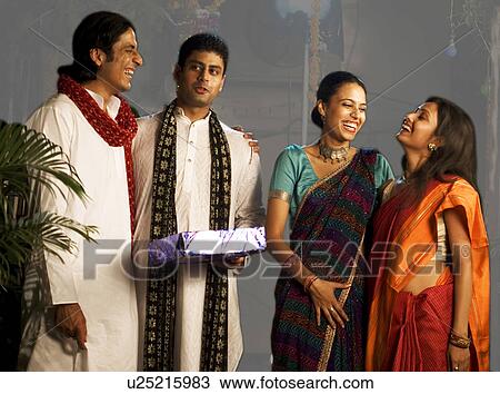 People exchanging gifts on Diwali View Large Photo Image Stock Image - People exchanging gifts on Diwali. Fotosearch