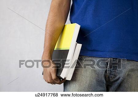 Student holding a book View Large Photo Image Stock Photo - Student holding a book. Fotosearch