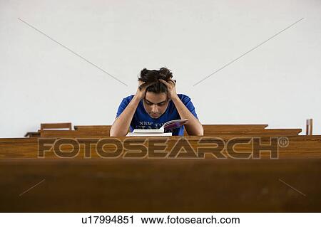 Stock Image - Students reading a book . Fotosearch