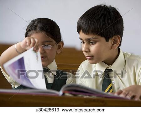 Students reading a book View Large Photo Image Stock Photo - Students reading a book . Fotosearch