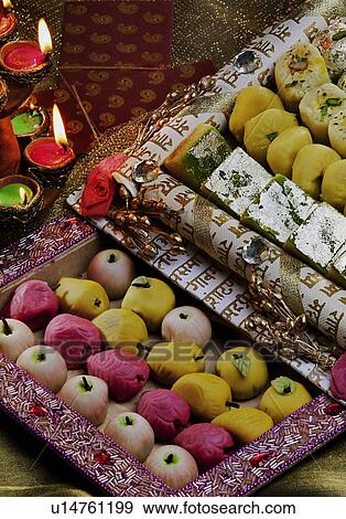 Sweet dishes and diyas View Large Photo Image Stock Photo - Sweet dishes and diyas. Fotosearch